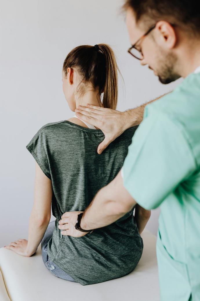 woman with a physio touching her back