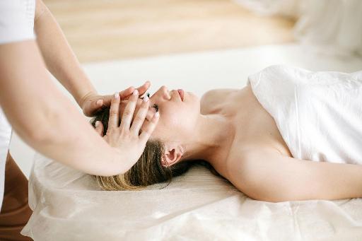 a woman has her head massaged